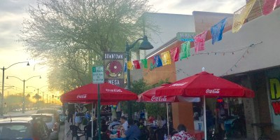 exterior of Mango's with customers seated on tables along the sidewalk