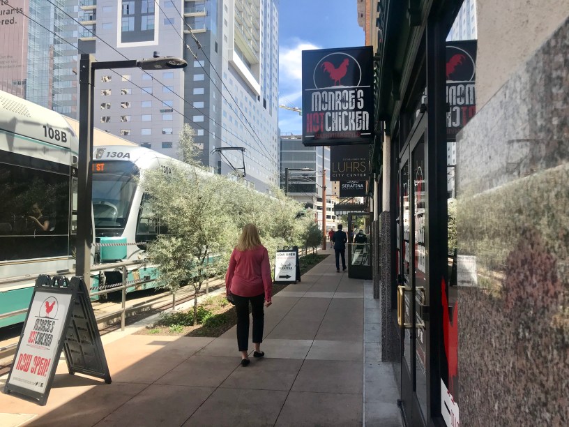 exterior of Monroe's Chicken with pedestrians on the sidewalk