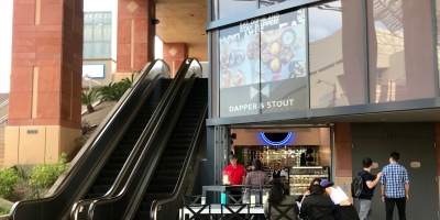 exterior of Dapper & Stout with customers gathered in front