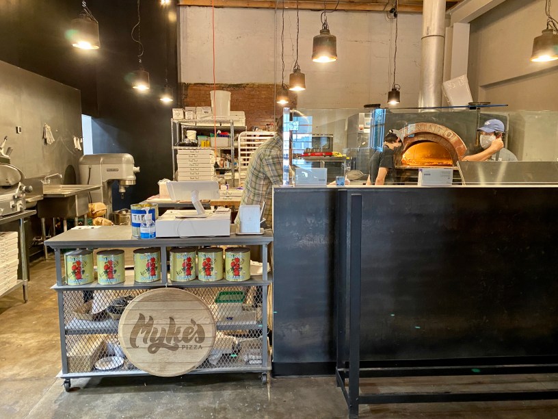 view of Myke's PIzza from inside Cider Corps