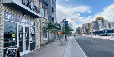 exterior of Kuka with a light rail train passing