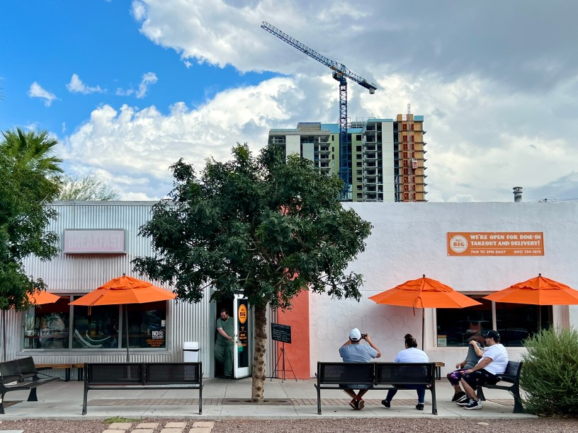 exterior of Matt's Big Breakfast with people waiting for tables and a construction crane in the background