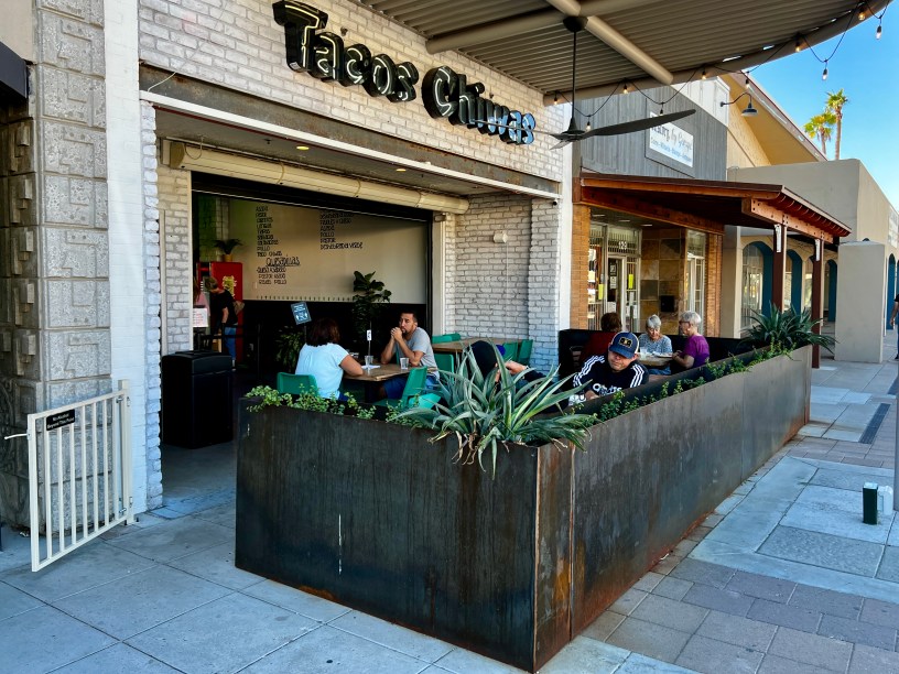 exterior of Tacos Chiwas with customers seated on the patio