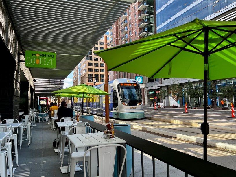 exterior of Morning Squeeze in downtown Phoenix with a light rail train in the background