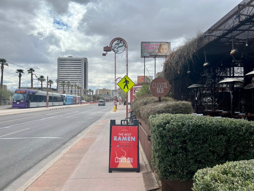 exterior of Clever Ko with a light rail train passing on Central Avenue