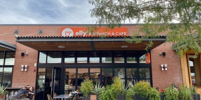 exterior of Elly's with customers and their dog on a shaded patio