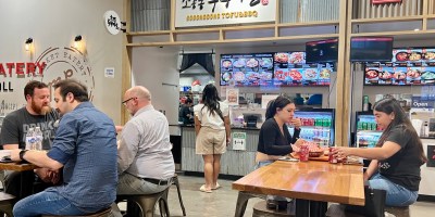 Sogongdong's stall in the Mekong Plaza food court with customers seated at tables and ordering at the counter