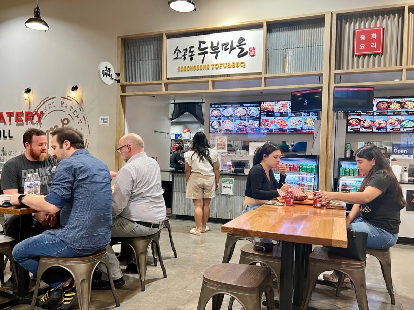 Sogongdong's stall in the Mekong Plaza food court with customers seated at tables and ordering at the counter