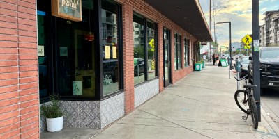 exterior of Pretty Penny a red brick facade and a bicycle parked on the sidewalk