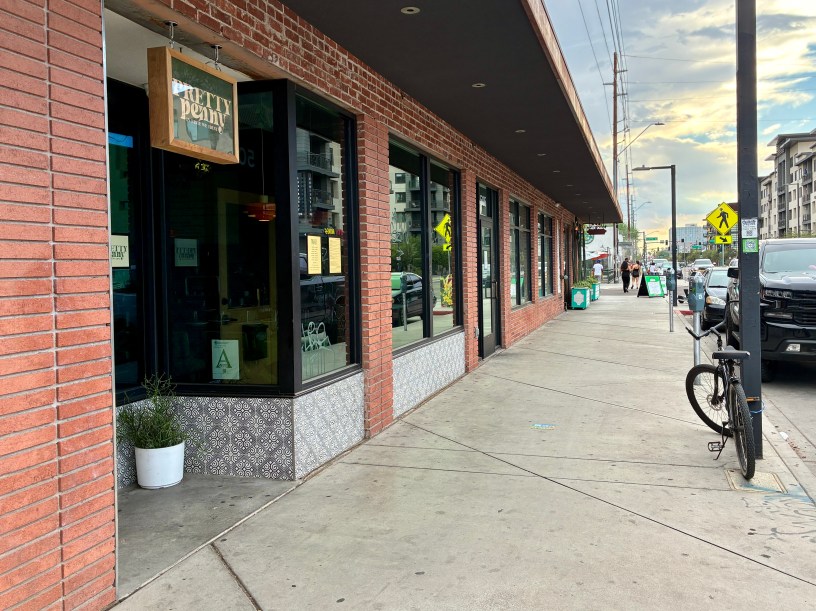 exterior of Pretty Penny a red brick facade and a bicycle parked on the sidewalk