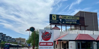 exterior of Yoshi's with a light rail train approaching on Central Avenue