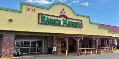 exterior of Los Altos Ranch Market with a green and red sign under a partly cloudy sky