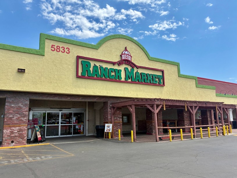 exterior of Los Altos Ranch Market with a green and red sign under a partly cloudy sky