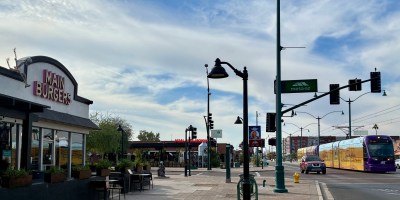 exterior of Main Burgers with a light train approaching on Main Street