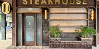 entrance of Cleaverman with the word "steakhouse" in large letter above and the phrase "true love is rare" on the window