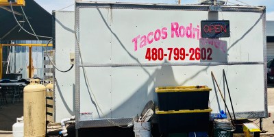 Back side of a trailer with "Tacos Rodgriguez" printed on a white surface.