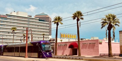 Exterior of Durant's as seen from Central Avenue with a light rail train passing the restaurant