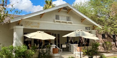 exterior of Matilda's with shade trees and diners eating on the patio