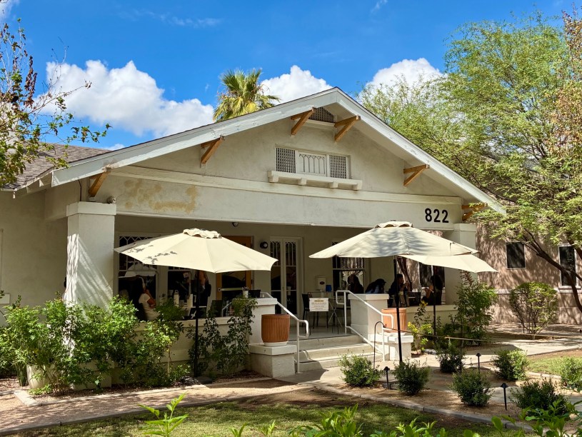 exterior of Matilda's with shade trees and diners eating on the patio